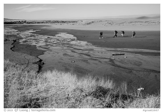 Backpackers hiking out of dunes. Great Sand Dunes National Park and Preserve (black and white)