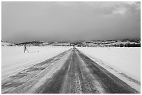 Road in winter at dusk, Gross Ventre valley. Grand Teton National Park, Wyoming, USA. (black and white)