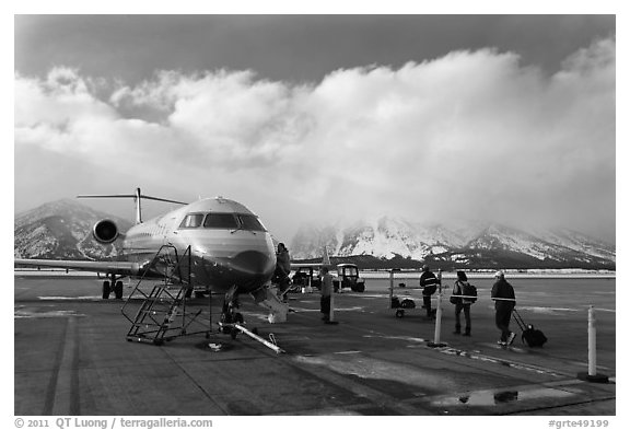 Passengers boarding aircraft, Jackson Hole Airport, winter. Grand Teton National Park (black and white)