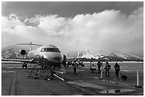 Passengers boarding aircraft, Jackson Hole Airport, winter. Grand Teton National Park ( black and white)