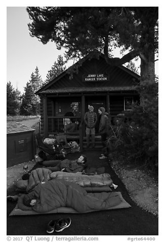 Outdoorsmen camping out in front of Jenny Lake Ranger Station for permits. Grand Teton National Park (black and white)