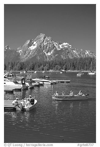 Boaters at Colter Bay marina with Mt Moran in the background, morning. Grand Teton National Park (black and white)