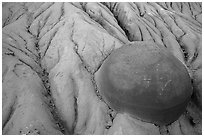 Cannonball concretion partly uncovered by erosion. Theodore Roosevelt National Park ( black and white)