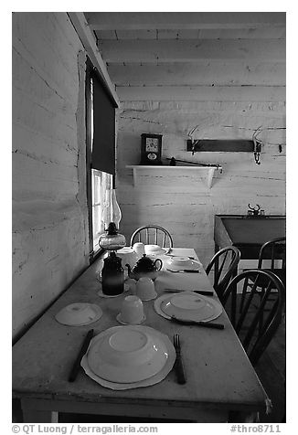 Dining table inside Roosevelt's Maltese Cross Cabin. Theodore Roosevelt National Park (black and white)