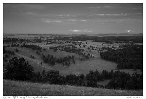Rolling hills with distant lightening storm at dusk. Wind Cave National Park (black and white)