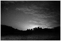 Prairie, pine trees on rolling hills at night. Wind Cave National Park, South Dakota, USA. (black and white)