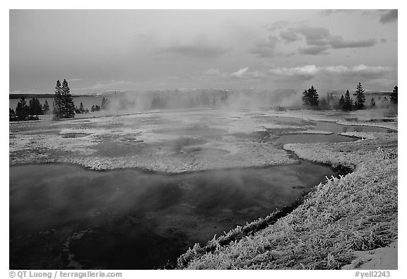 West Thumb Geyser Basin covered by snow at dusk. Yellowstone National Park, Wyoming, USA.