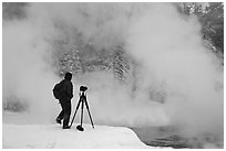 Photographer standing next to hot springs. Yellowstone National Park, Wyoming, USA. (black and white)