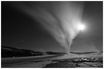 Old Faithful Geyser erupts at night. Yellowstone National Park, Wyoming, USA. (black and white)