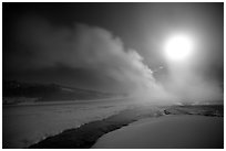 Run-off and geyser, steam obscuring moon, Old Faithful. Yellowstone National Park ( black and white)