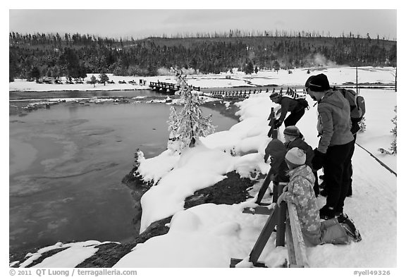 Family looks at thermal pool in winter. Yellowstone National Park (black and white)