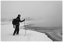 Skier at the edge of thermal pool. Yellowstone National Park, Wyoming, USA. (black and white)