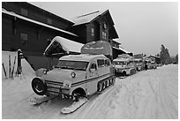 Snow busses in front of Old Faithful Snow Lodge. Yellowstone National Park, Wyoming, USA. (black and white)