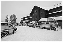 Winter Snowcoaches in front of Old Faithful Snow Lodge. Yellowstone National Park, Wyoming, USA. (black and white)