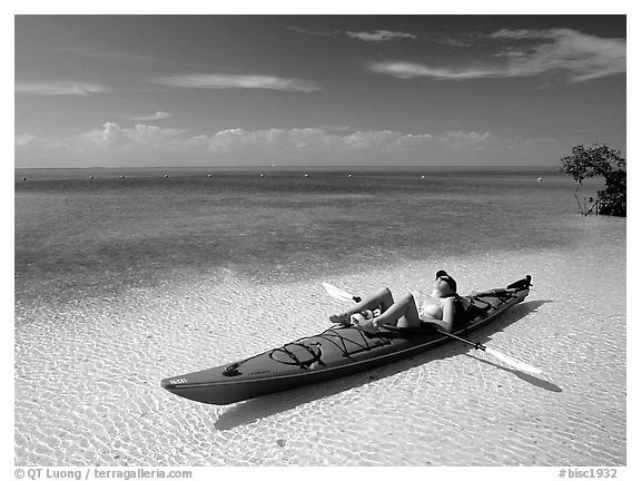 Woman reclining in kayak on shallow waters,  Elliott Key. Biscayne National Park (black and white)