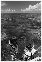 Snorkelers entering water. Biscayne National Park, Florida, USA. (black and white)