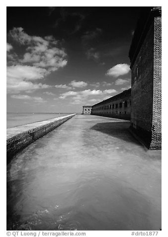 Fort Jefferson moat and massive brick wall on a sunny dayl. Dry Tortugas National Park (black and white)