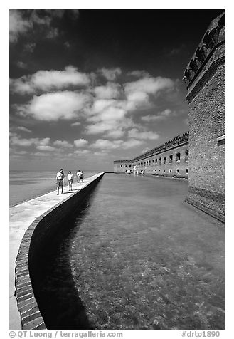 Tourists walking on seawall. Dry Tortugas National Park (black and white)