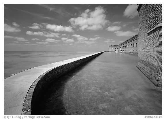 Seawall, moat, and rampart on a calm sunny day, Fort Jefferson. Dry Tortugas National Park (black and white)