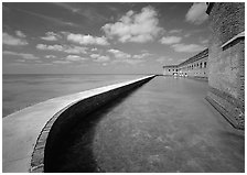 Seawall, moat, and rampart on a calm sunny day, Fort Jefferson. Dry Tortugas National Park, Florida, USA. (black and white)