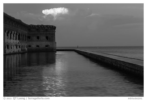Moat, fort, bright cloud at dawn. Dry Tortugas National Park (black and white)
