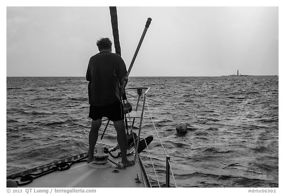 Sailor getting ready to hook mooring buoy near Loggerhead Key. Dry Tortugas National Park (black and white)