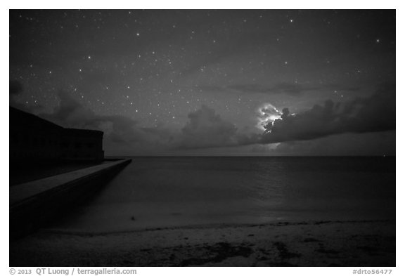 Fort Jefferson and beach at night with cloud electric storm. Dry Tortugas National Park (black and white)