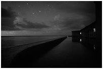 Fort Jefferson at night with stars and light from storm. Dry Tortugas National Park ( black and white)