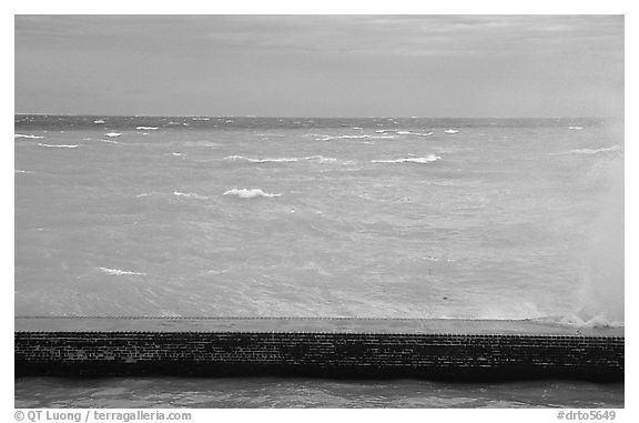 Seawall battered by surf on a stormy day. Dry Tortugas National Park (black and white)