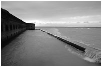 Seawall and moat with waves on stormy day. Dry Tortugas National Park, Florida, USA. (black and white)