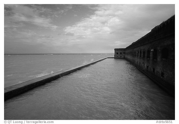 Seascape with fort seawall and moat on cloudy day. Dry Tortugas National Park, Florida, USA.
