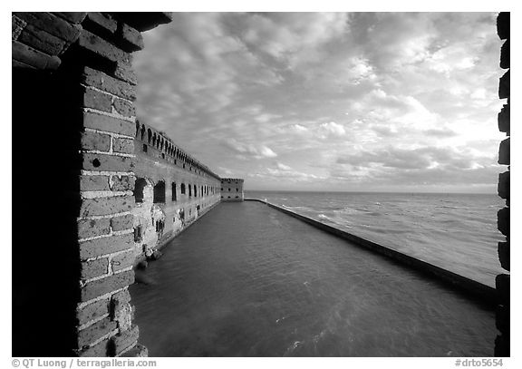 Fort Jefferson wall and moat, framed by cannon window. Dry Tortugas National Park (black and white)