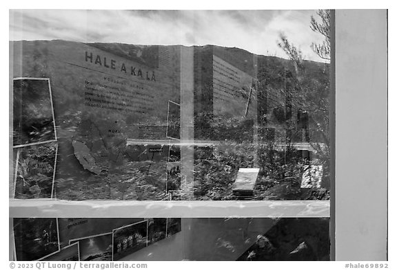 Haleakala slopes and native garden with signs, Park Headquarters Visitor Center window reflexion. Haleakala National Park (black and white)