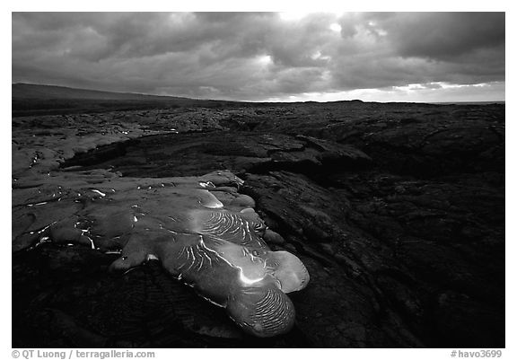 Flowing lava and rain clouds at dawn. Hawaii Volcanoes National Park (black and white)
