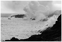 Steam rising off lava flowing into ocean. Hawaii Volcanoes National Park ( black and white)