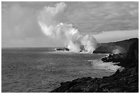 Billowing coastal smoke plume carries toxic sulphur dioxide as lava enters Pacific Ocean. Hawaii Volcanoes National Park, Hawaii, USA. (black and white)