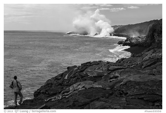 Park visitor looking, lava ocean entry plume. Hawaii Volcanoes National Park (black and white)