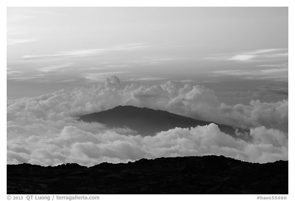 Puu Waawaa summit emerging from sea of clouds at sunset. Hawaii Volcanoes National Park (black and white)
