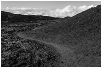 Trail through olivine hill bordering aa lava. Hawaii Volcanoes National Park ( black and white)