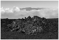 Black of colorful lava on Mauna Loa, Mauna Kea emerging from Saddle clouds. Hawaii Volcanoes National Park ( black and white)
