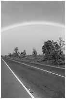 Rainbow above highway. Hawaii Volcanoes National Park, Hawaii, USA. (black and white)