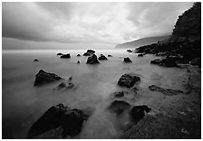 Seascape with smooth water, clouds and rocks, Siu Point, Tau Island. National Park of American Samoa ( black and white)