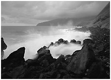 Stormy ocean and balsalt boulders, Siu Point, Tau Island. National Park of American Samoa ( black and white)