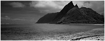 Tropical landscape with blue waters, pointed peaks, and clouds, Ofu Island. National Park of American Samoa (Panoramic black and white)
