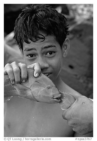 Samoan boy with freshly catched tropical fish, Tau Island. National Park of American Samoa (black and white)