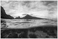 Over-under split view of Ofu South Beach Lagoon and jagged mountains. National Park of American Samoa ( black and white)