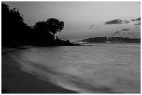 Honeymoon beach at dusk with lights of St Thomas. Virgin Islands National Park ( black and white)