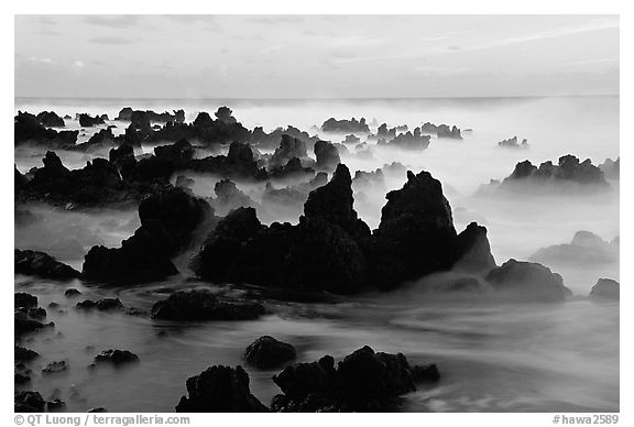 Volcanic rocks and waves at sunrise, Keanae Peninsula. Maui, Hawaii, USA (black and white)