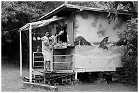 Man shopping at decorated fruit stand. Oahu island, Hawaii, USA ( black and white)