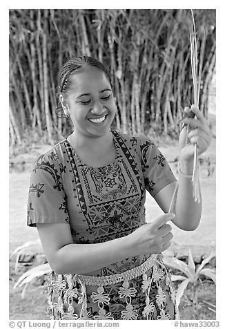Tonga woman showing how to make cloth out of Mulberry bark. Polynesian Cultural Center, Oahu island, Hawaii, USA (black and white)